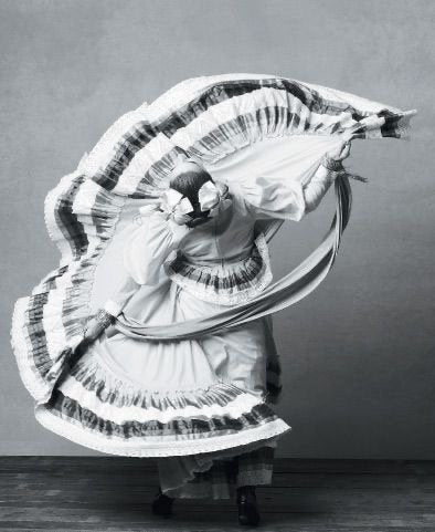 Una bailarina con falda amplia en pleno giro, en blanco y negro